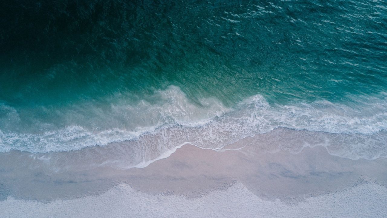 Ocean waves crashing on a sandy beach