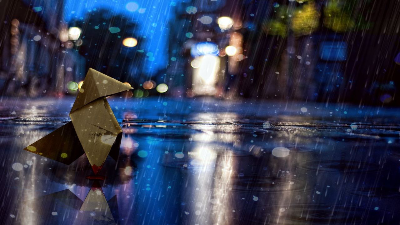 Origami bird in the rain reflecting on street