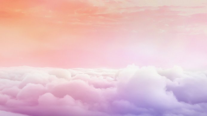 Pink and purple pastel sky with fluffy clouds