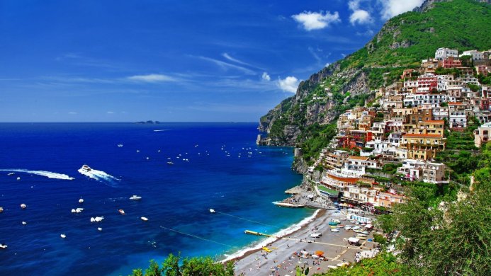 Positano, Italy coastal view with colorful houses, blue sea, and boats