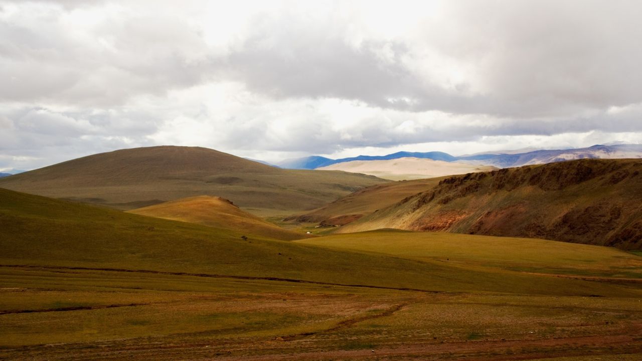 Rolling hills landscape with cloudy sky