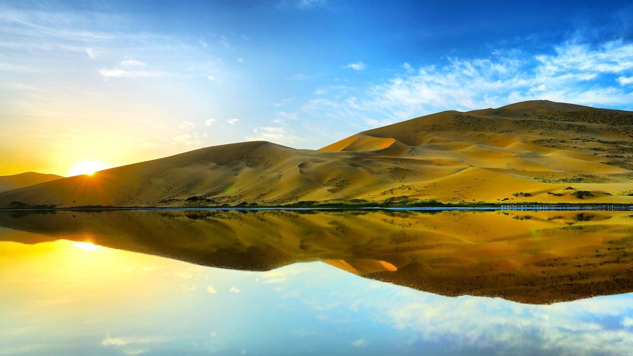 Sand dunes reflecting in the water