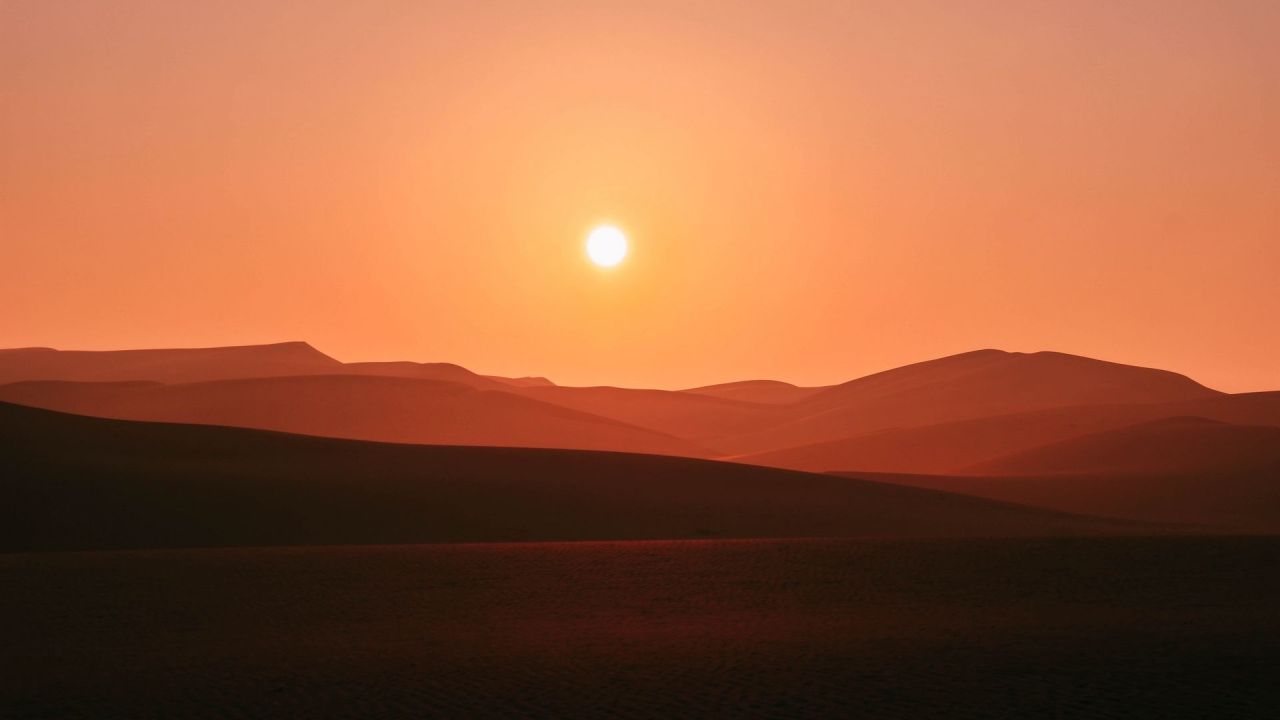 Desert sand dunes at sunset