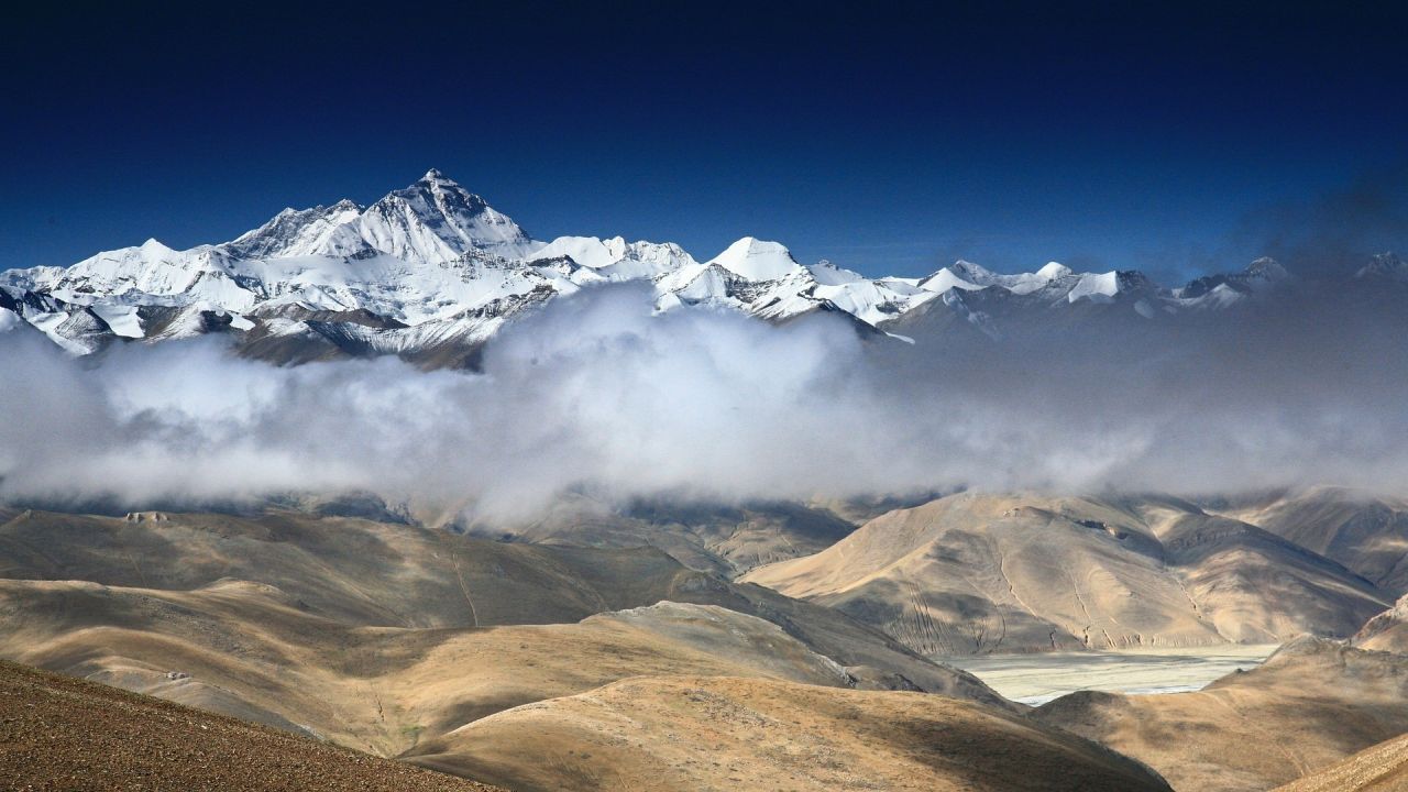 Snowy mountains and clouds landscape