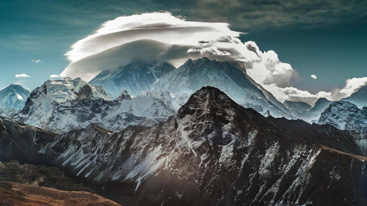 Snowy mountain peaks with cloud cover