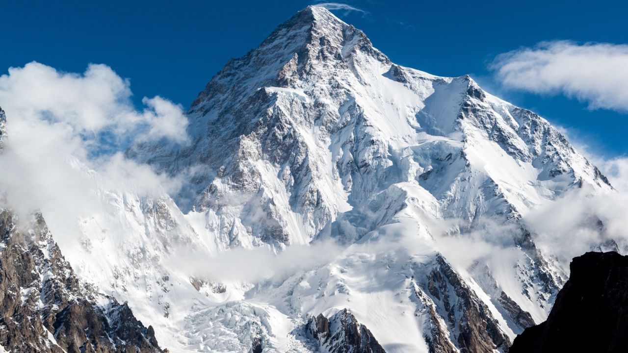 Snowy mountain peak with clouds
