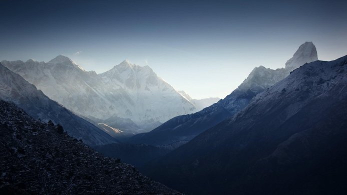 Snowy mountain range with a clear blue sky above the peaks
