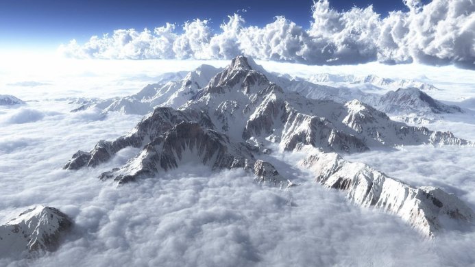 Snow-capped mountains piercing through a sea of clouds under a blue sky