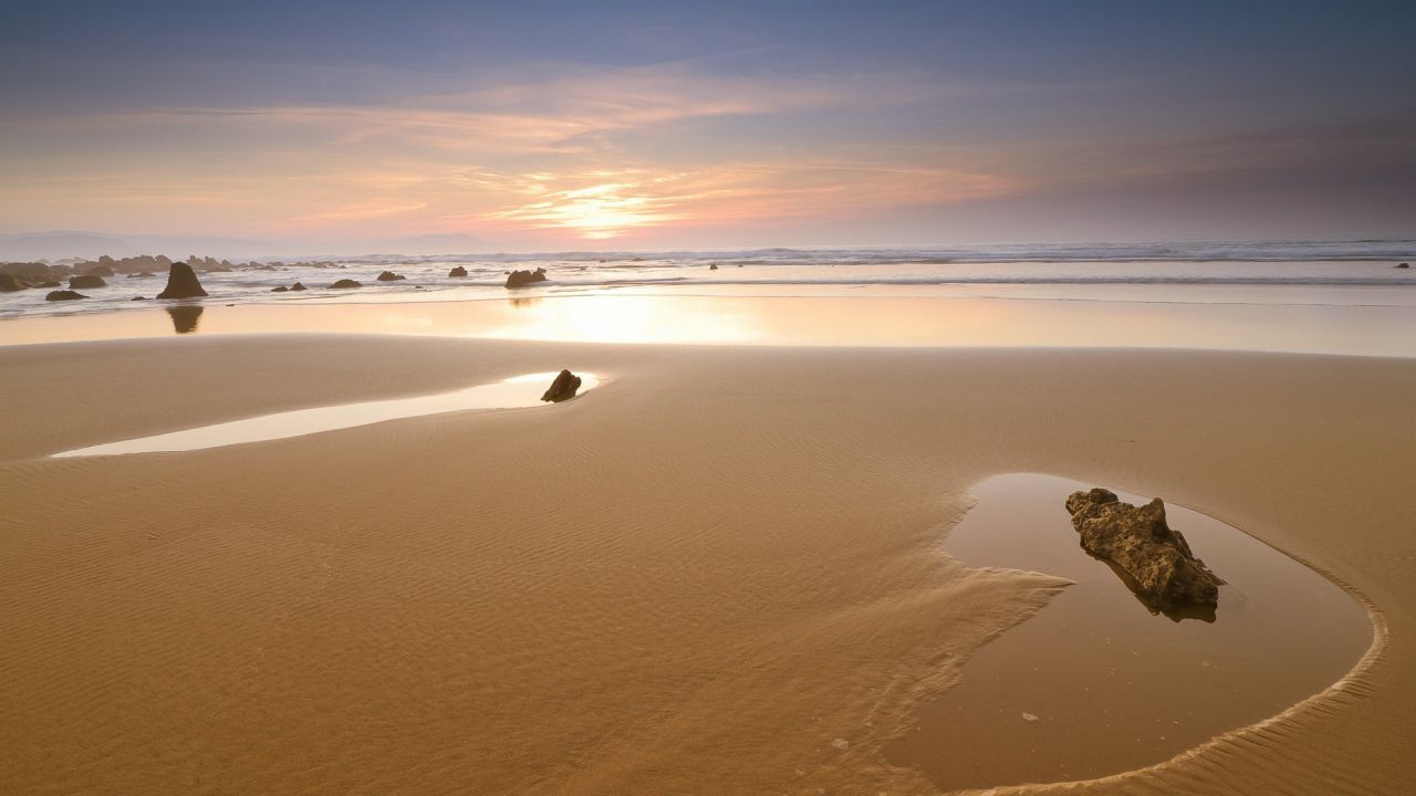 Beach with rocks at sunset