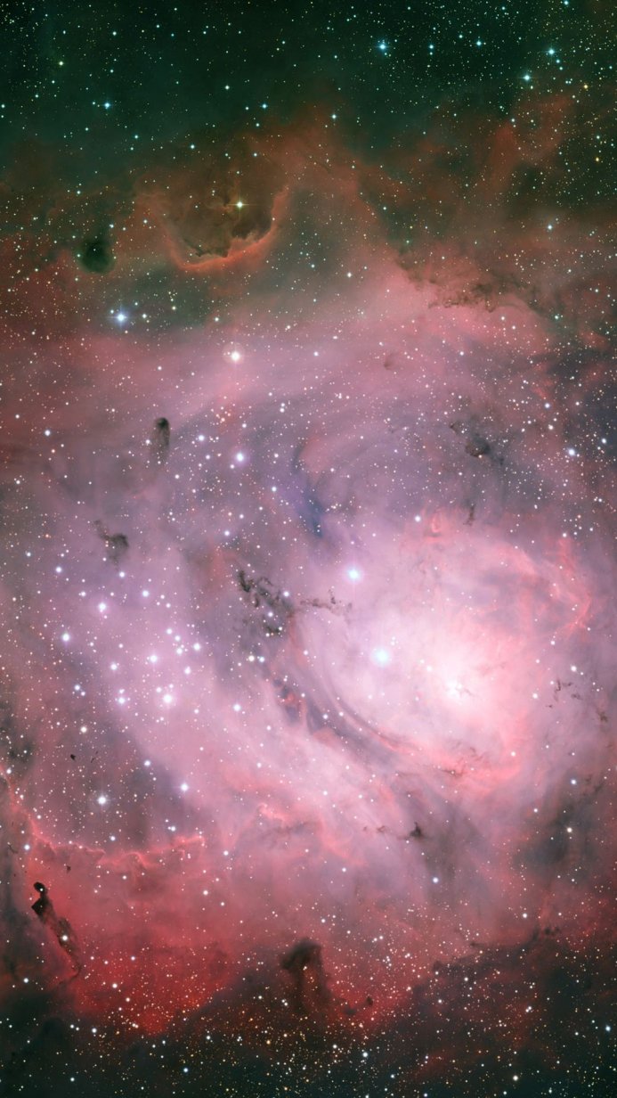 A pink and red nebula with many stars