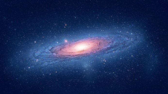 A spiral galaxy with a bright center and countless stars in a deep blue sky