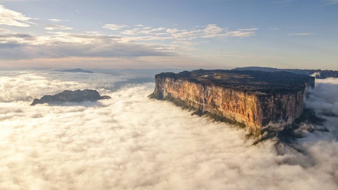 Aerial view of a table mountain surrounded by clouds