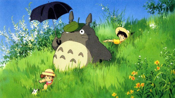 Totoro with Satsuki and Mei from My Neighbor Totoro in a field of grass