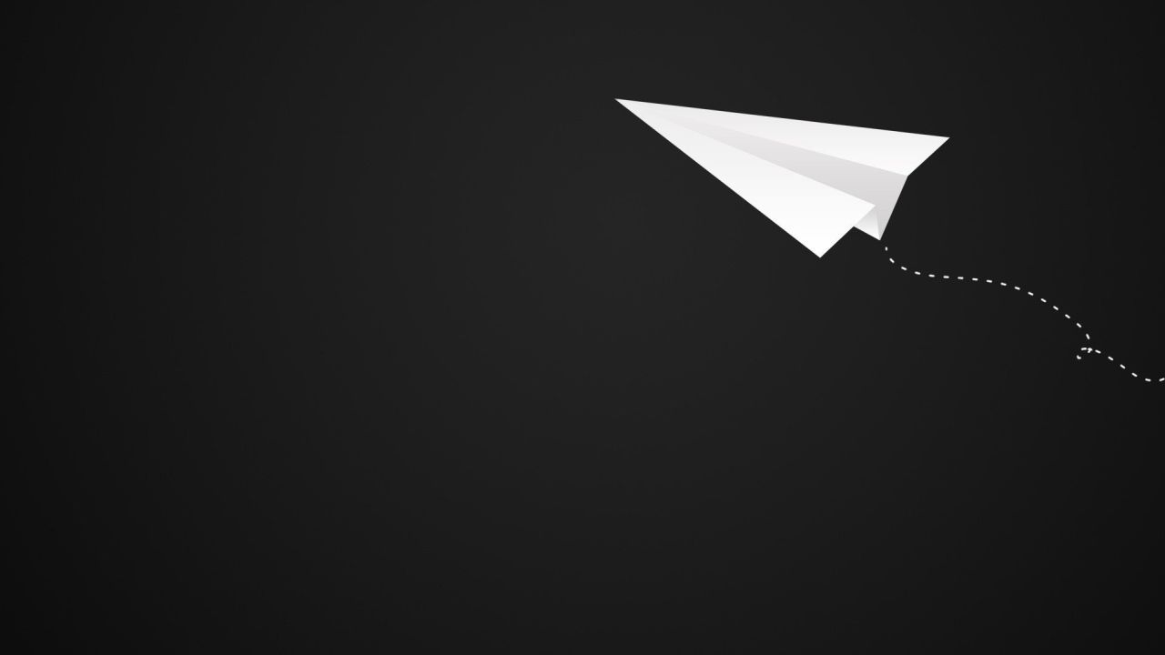 White paper airplane flying on black background with trail