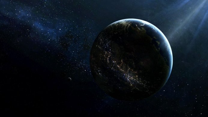 Planet Earth and the Moon in the darkness of space with visible city lights