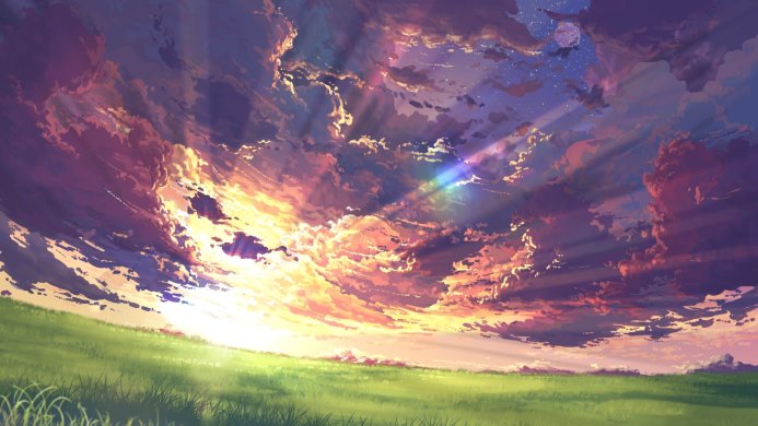 A beautiful sunset sky with clouds over a green field