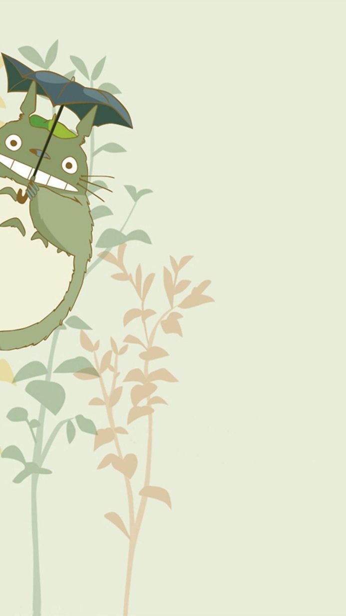 Totoro from My Neighbor Totoro holding an umbrella in a plant background