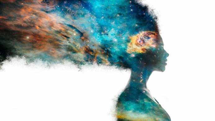 Silhouette of a woman filled with a vibrant galaxy against a white background
