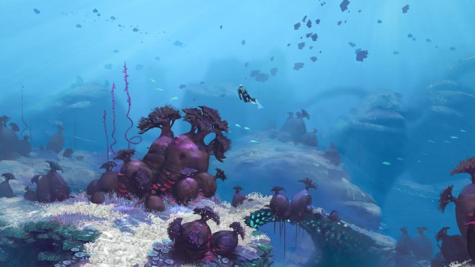 A diver explores a vibrant coral reef in a blue ocean with unique purple coral formations