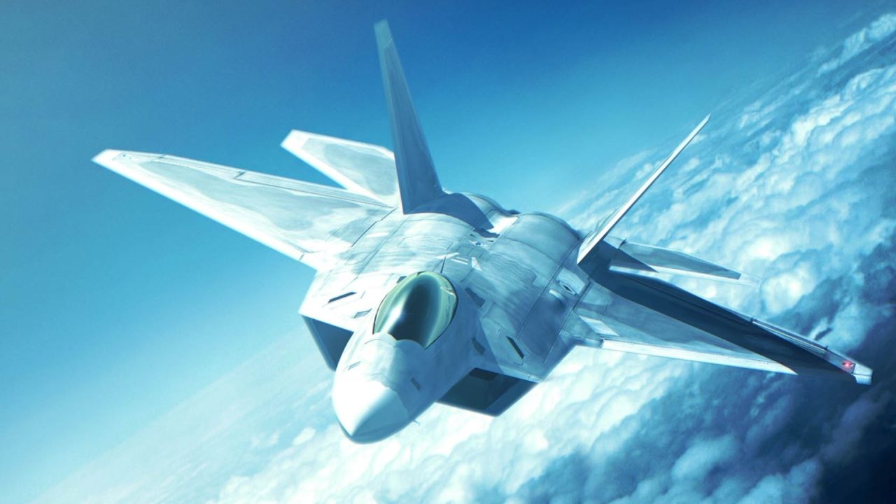 Fighter jet flies high above clouds in blue sky