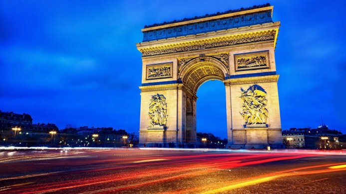 Arc de Triomphe in Paris at night with light trails from traffic