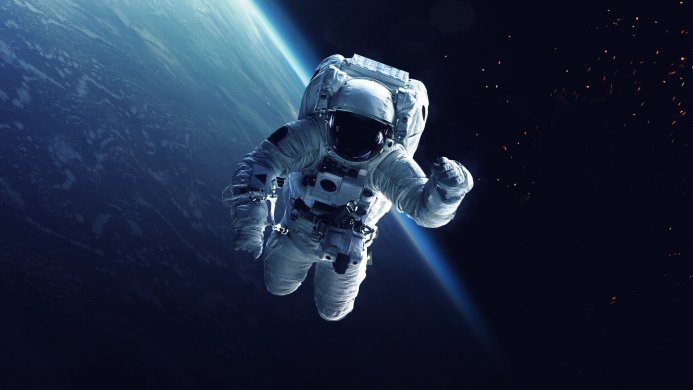 An astronaut floats in space with the Earth in the background