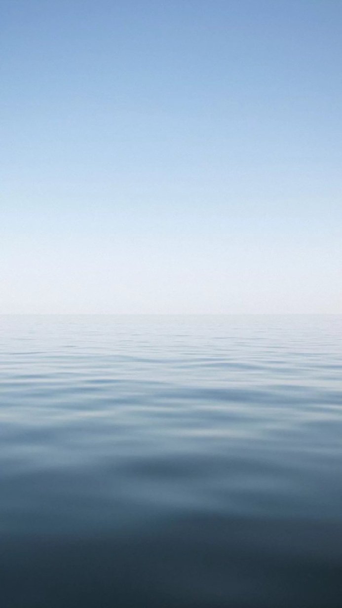 Still blue sea under a clear sky