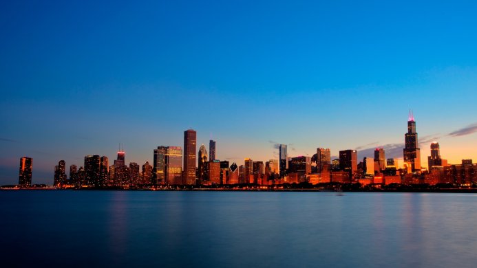 Chicago skyline at twilight with city lights reflecting on the water