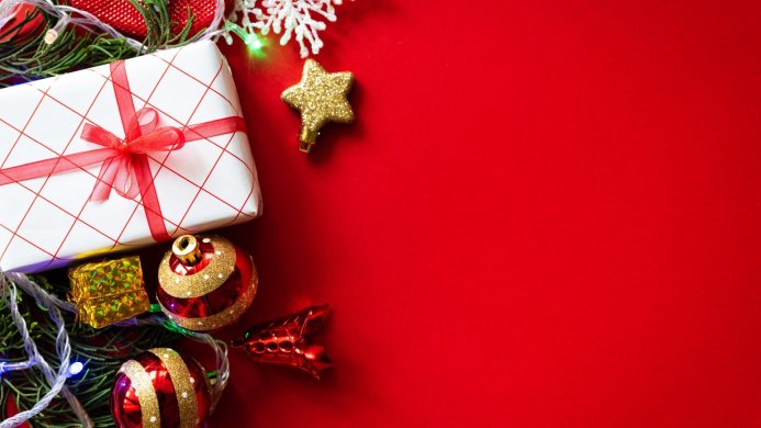 A christmas gift with ornaments on a red background