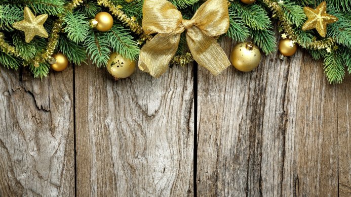 Christmas ornaments and fir branches on a wooden background