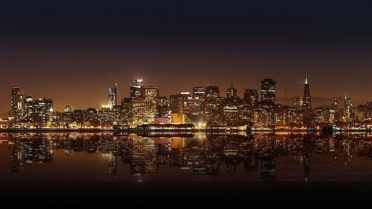 Night city skyline reflecting on water