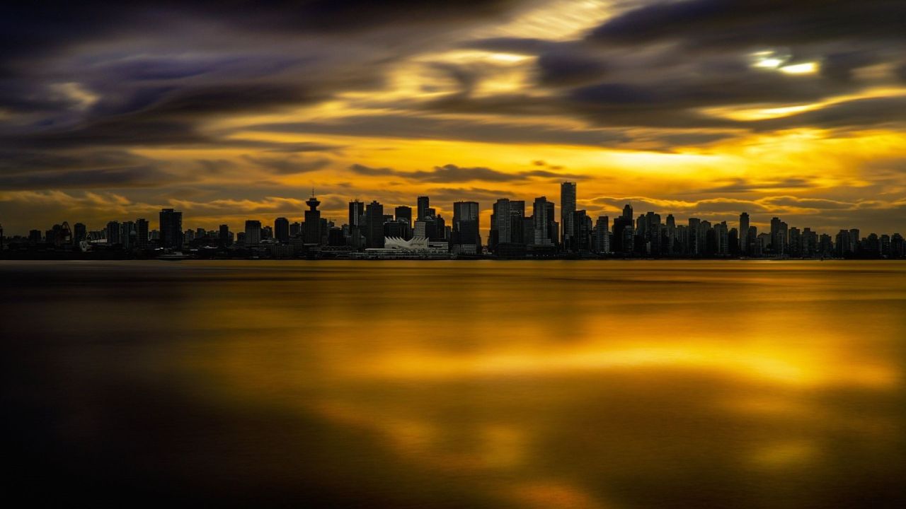 City skyline at sunset reflected in water