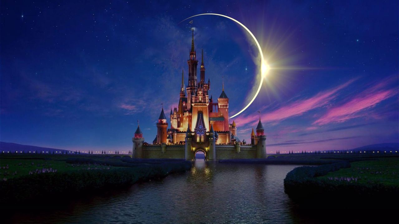 Disney castle at night with moon