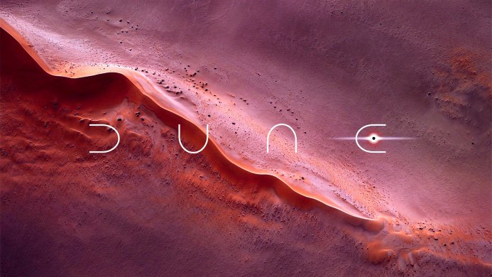Aerial view of sand dunes with the "Dune" logo