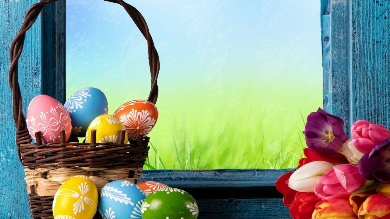 Easter eggs in a basket with tulips