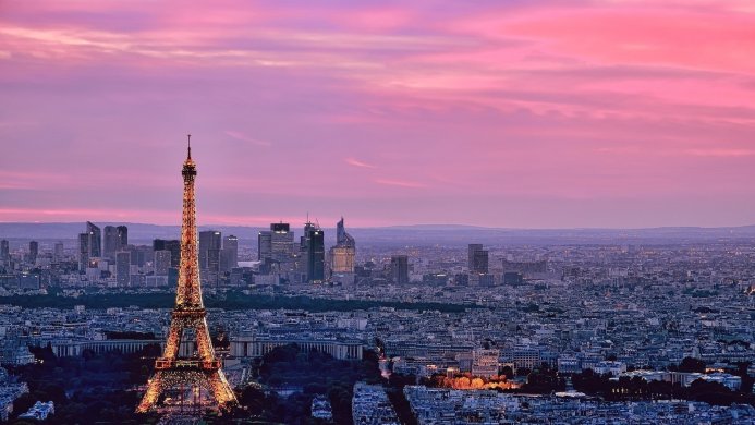 Eiffel Tower and Paris cityscape at sunset with pink and purple sky