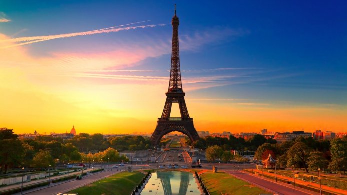 Eiffel Tower at sunset in Paris, France. Warm light and blue sky