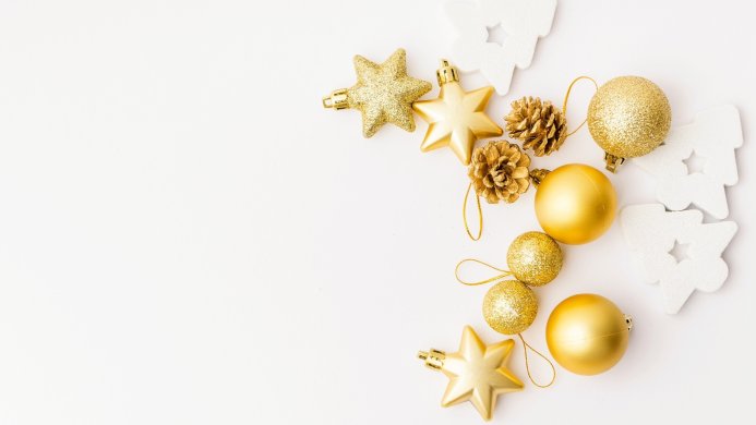 Gold Christmas ornaments and white decorative Christmas trees on a white background
