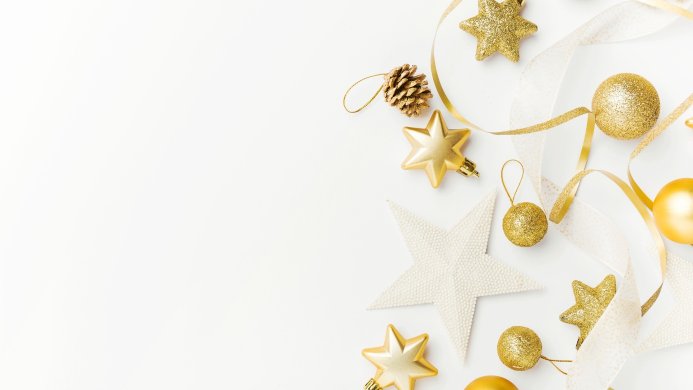 Golden Christmas decorations: stars, pine cone, balls and ribbon on white background