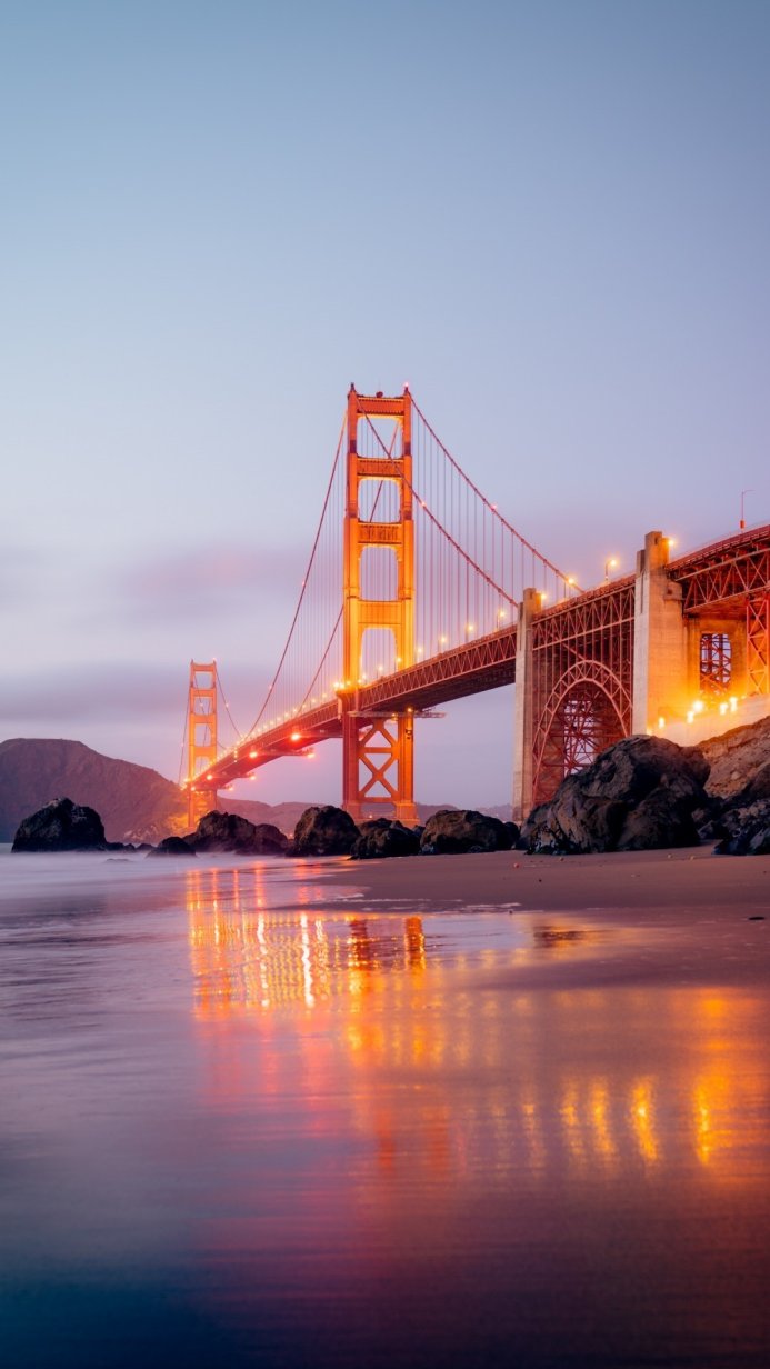 Golden Gate Bridge at twilight reflecting in the water