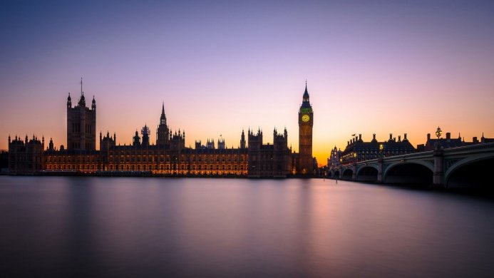 Houses of Parliament and Big Ben at dusk, reflected in the River Thames