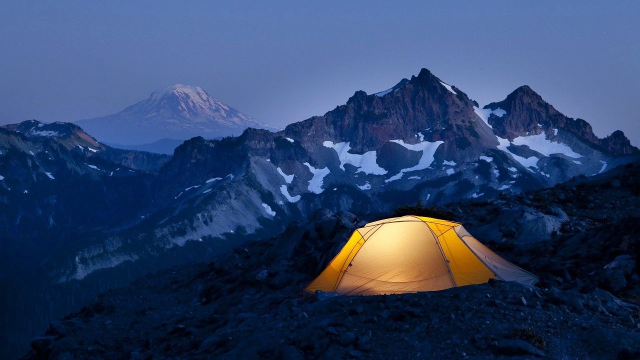 Illuminated tent at night mountains