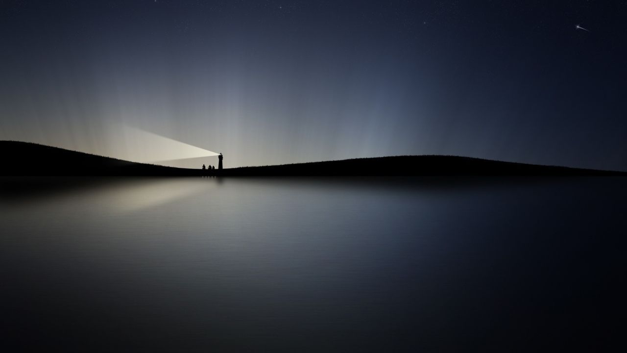 Lighthouse on a hill at night
