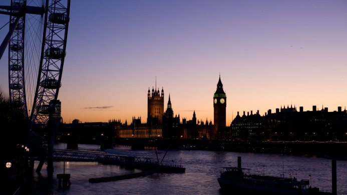 Silhouette of the London Eye and Houses of Parliament with Big Ben at sunset