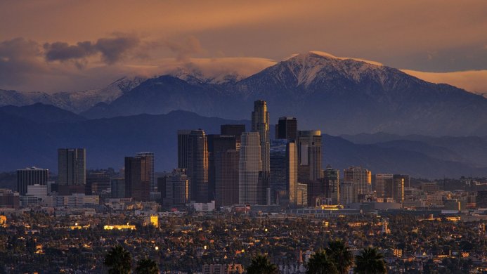 Los Angeles skyline at sunset with mountains in the background