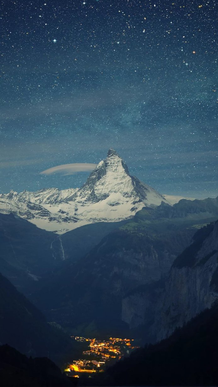 Matterhorn mountain and small village under a starry night sky