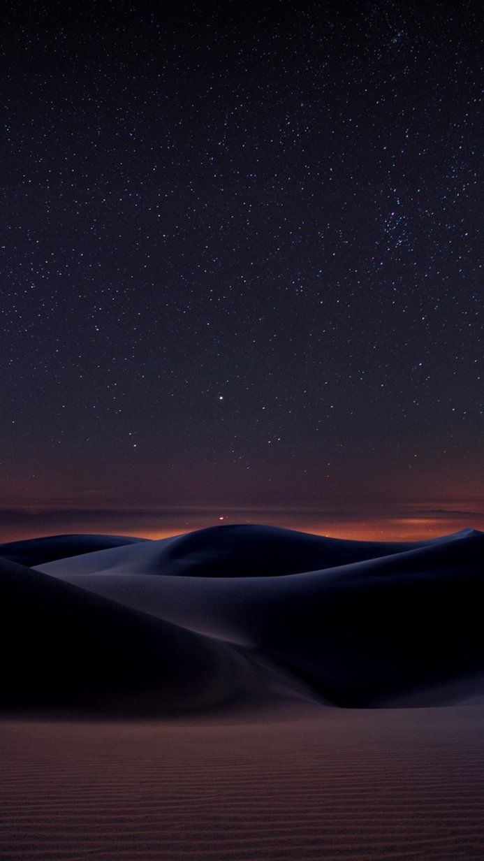 Starry sky over sand dunes at night