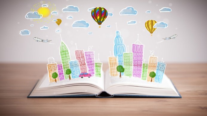 Open book with colorful drawn cityscape, balloons, airplane, car, sun, clouds