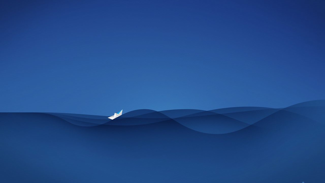 Paper boat on blue water