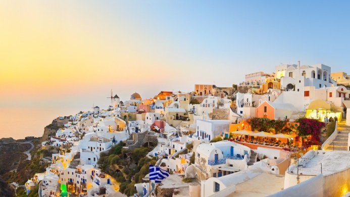 Santorini, Greece: A picturesque village on a hillside at sunset
